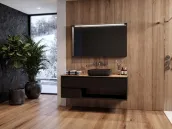 Elevate your bathroom with this stunning 150cm wide suspended vanity, finished in a rich RAL 8019 matte lacquer. The unit boasts a spacious 46cm depth and 50cm height, with a sleek, wall-mounted design that creates a sense of openness. The vanity features a luxurious HPL Ancient Oak countertop, 1.2cm thick, and comes complete with a matching Mood60 tekhnos RAL 8019 washbasin and a fabulous LED-lit mirror with a wooden frame, 13cm thick, 75cm high and 130cm wide.